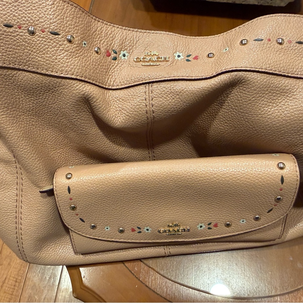 Coach Baby Pink Leather Shoulder Bag with Floral Accents and matching wallet.